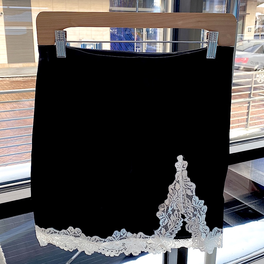 never worn before, size 4, adorable black mini skirt with lace and slit